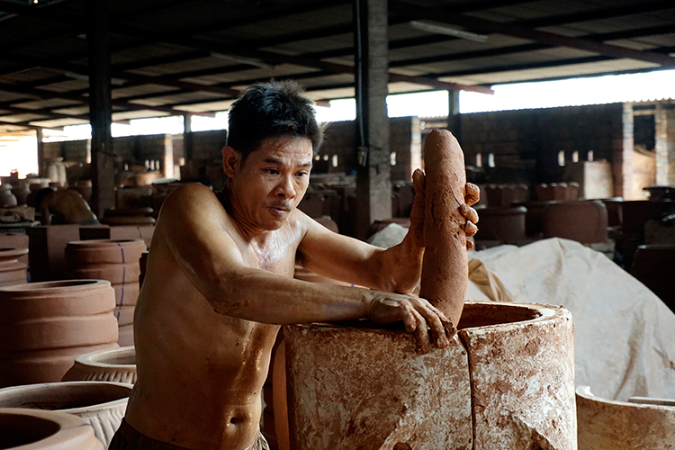 Pressing clay into mould