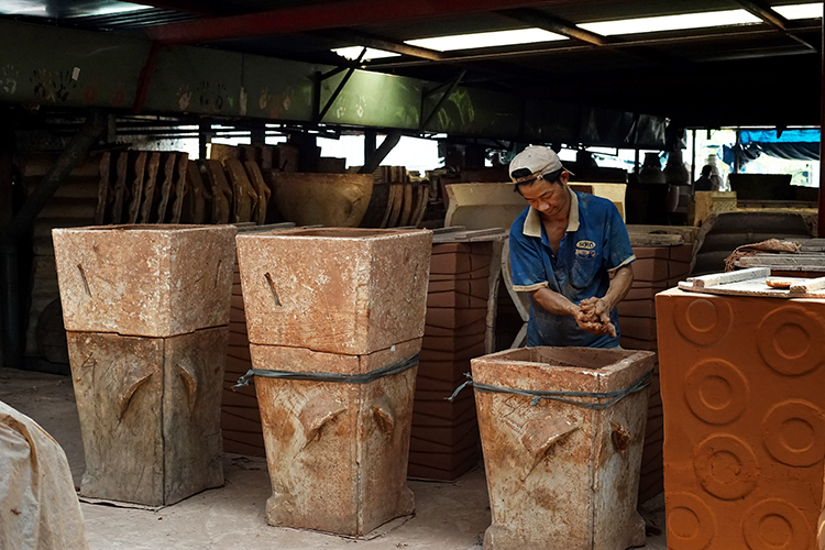 Pressing clay into mould